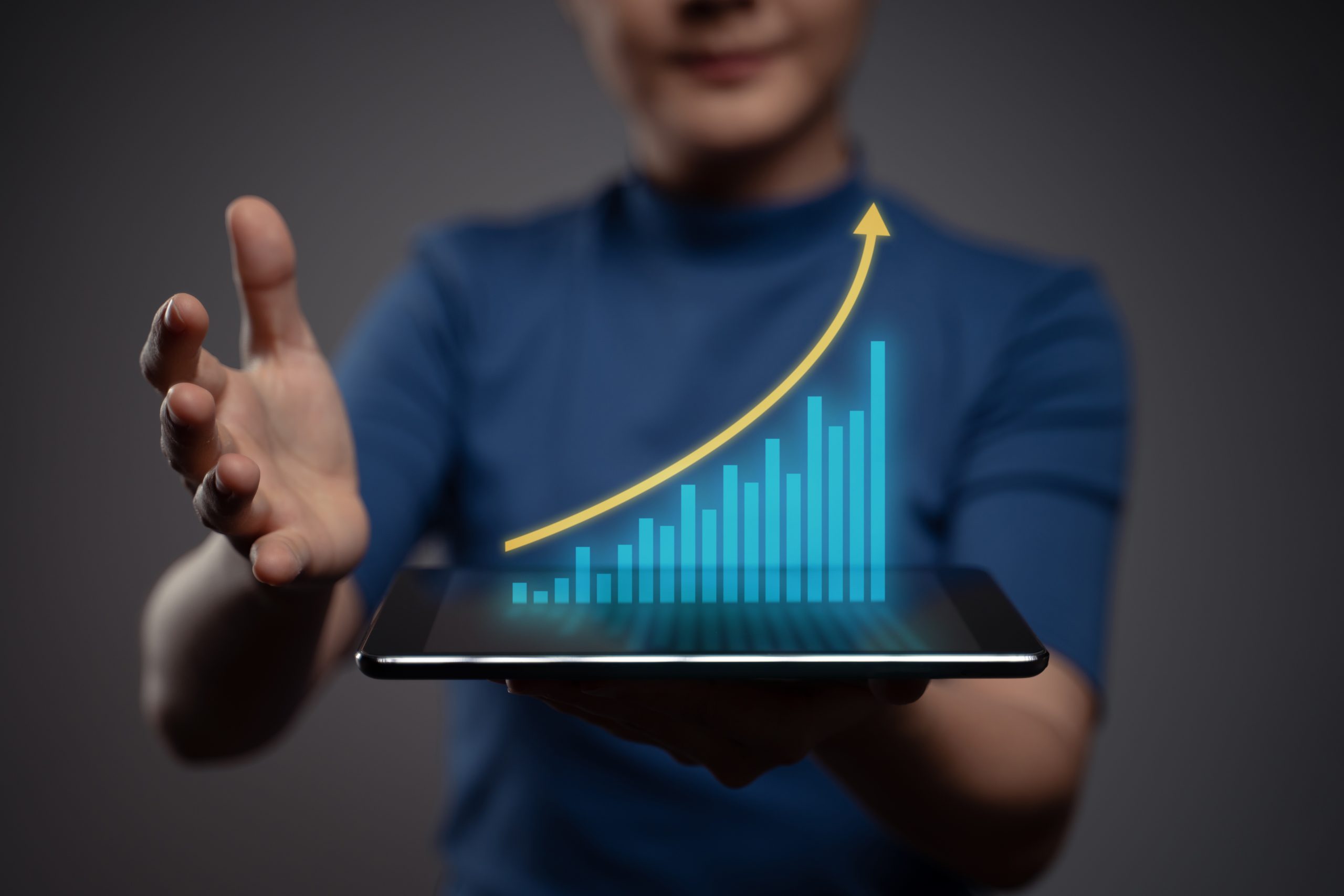 woman-using-tablet-planning-digital-marketing-with-chart-hologram-effect-scaled