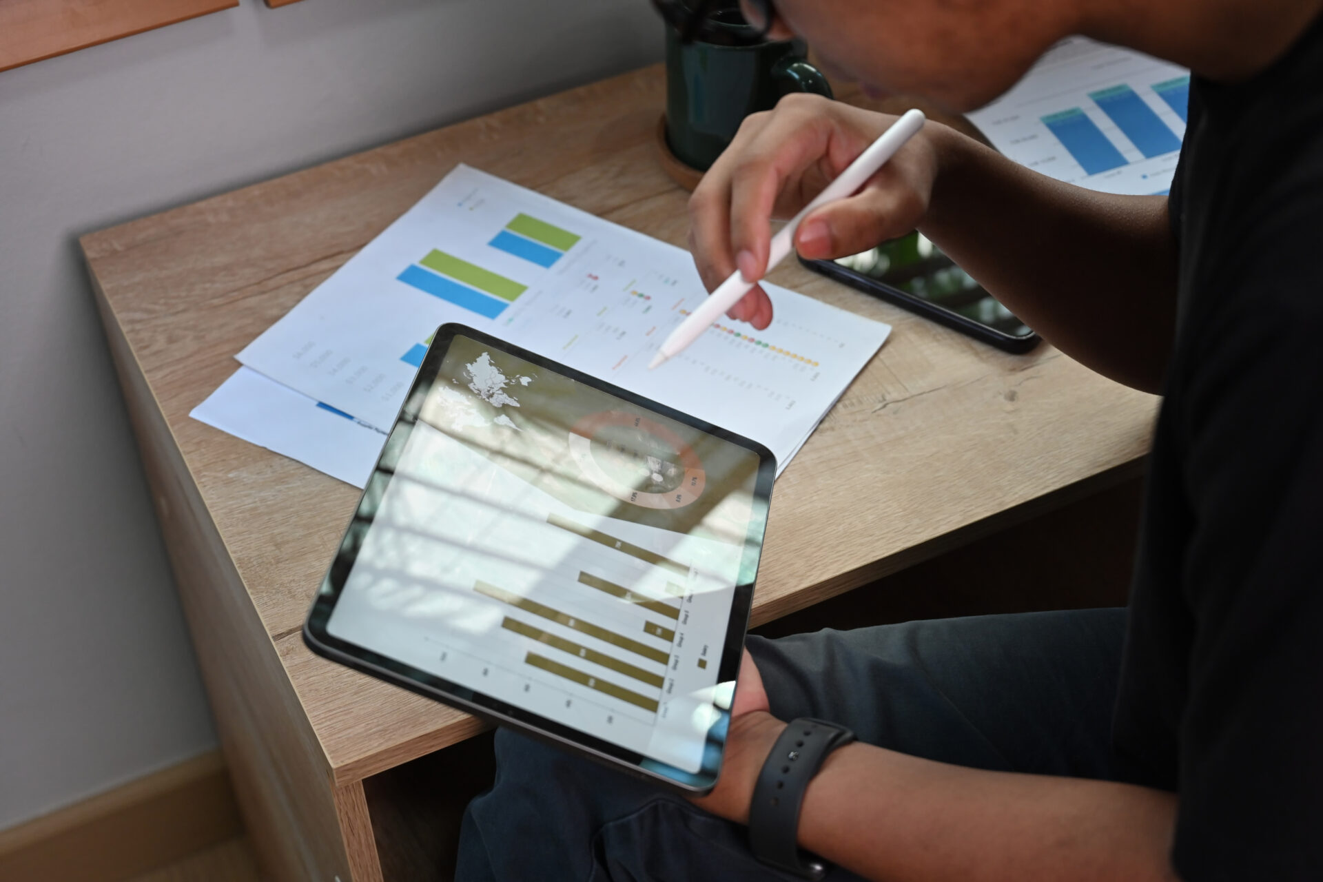 Cropped shot businessman holding digital tablet with financial g